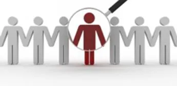 A magnifying glass picking one figure out of a row of stylised people